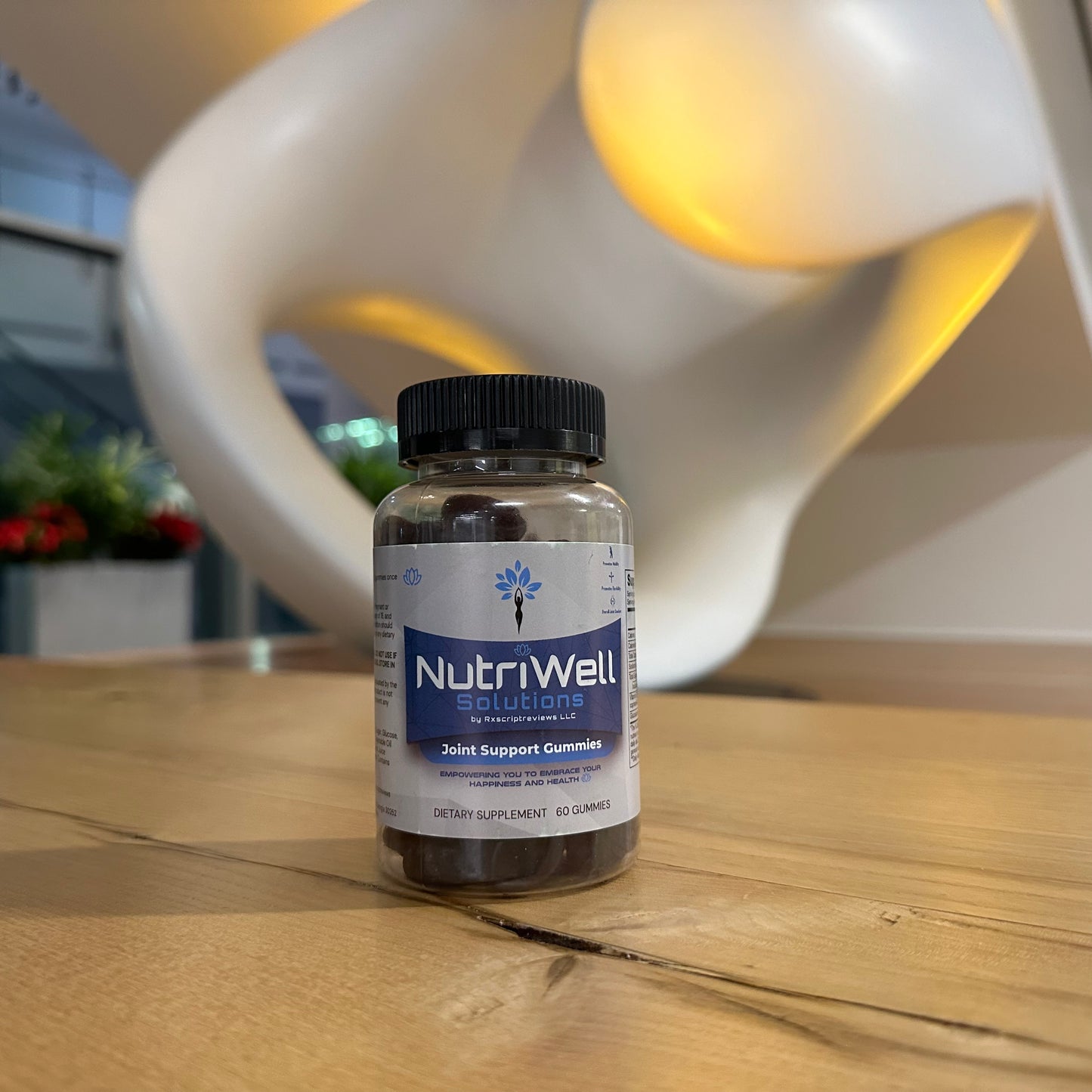 NutriWell Joint Support Gummy Bottle with art statue in Emory University Hospital lobby, Atlanta, Georgia.