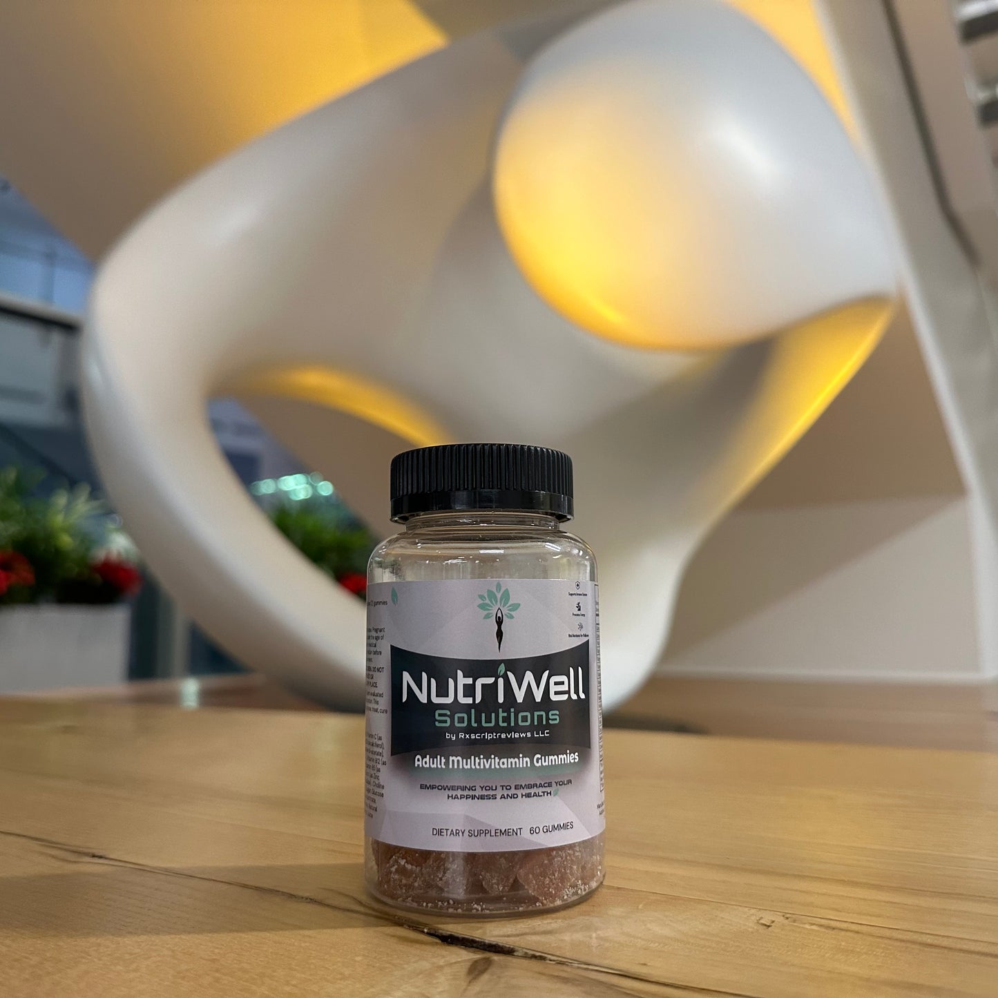 NutriWell Multivitamin Gummy Bottle with art statue in Emory University Hospital lobby, Atlanta, Georgia."