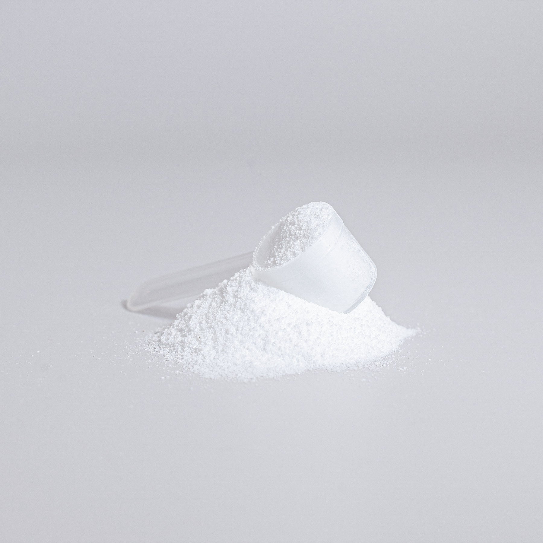 NutriWell Solutions’ Pure Creatine Monohydrate powder and scoop